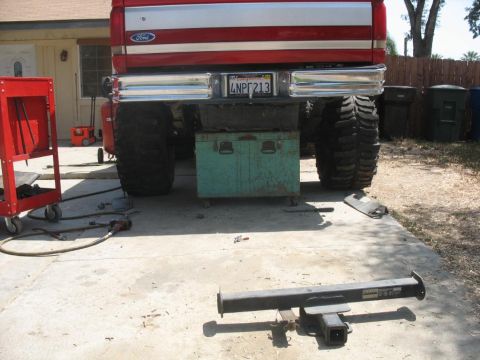 1987 Ford Bronco - Rear view of a 1987 Ford Bronco, modified with oversized tires and a prominent hitch receiver.