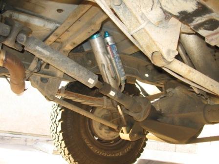 1984 Ford Bronco - Vehicle's undercarriage features aftermarket Fox shocks and suspension components.