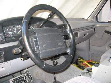 1984 Ford Bronco - The interior of a 1987 Ford Bronco, with a focus on the dashboard and steering wheel.
