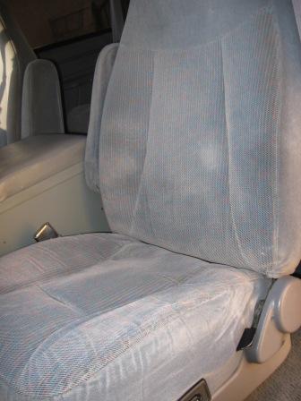 1984 Ford Bronco - Interior view of gray fabric bucket seats and center console.