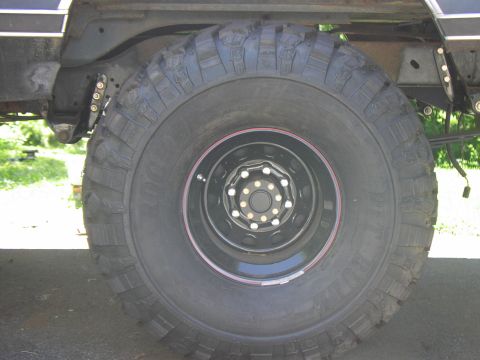 1986 Ford Bronco - Close-up view of a vehicle's tire and suspension system.