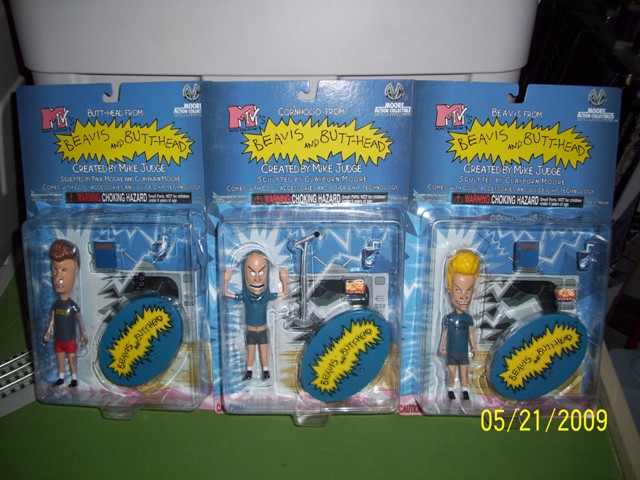 Three Beavis and Butt-Head action figures in original packaging, with date 05/21/2009 visible