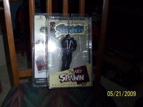 1991 Ford Bronco - Two Spawn action figures are displayed in their original packaging on a chair.