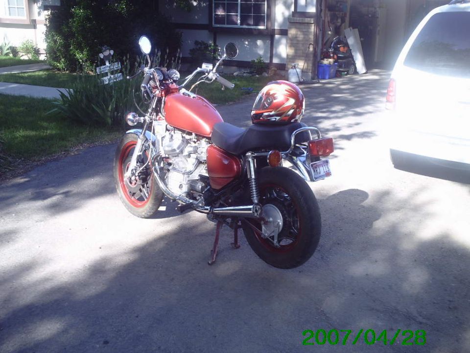 1980 Honda CX500 motorcycle parked outside, red helmet on seat