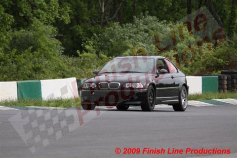 2002 BMW M3 - A black 2002 BMW M3 navigates a turn on a race track.