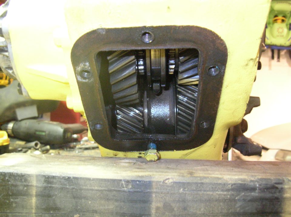 Remove the P.T.O cover to retrieve the roll pin and freeze plugg from the case. I used a telescoping magnet.