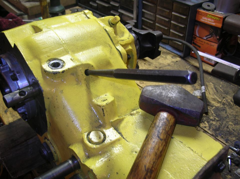 Drive in freeze plugg and use the same hole to drive in the roll pin that holds the shift fork to the rail. You'll have to move the rail in and out to look in hole and see it. Knock it all the way in till it falls into case and leave the punch in for a moment.