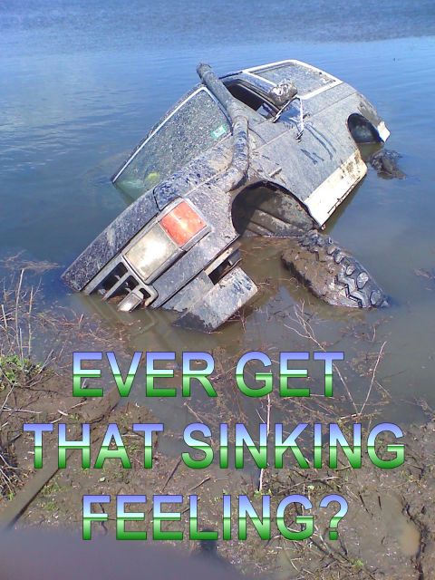 1990 Ford Bronco - This SUV is partially submerged in water, with a snorkel visible on the roof.