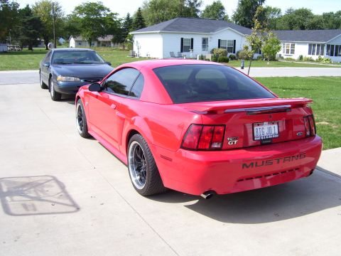 2004 Ford Mustang - Rear view of a red 2004 Ford Mustang GT with a custom license plate.