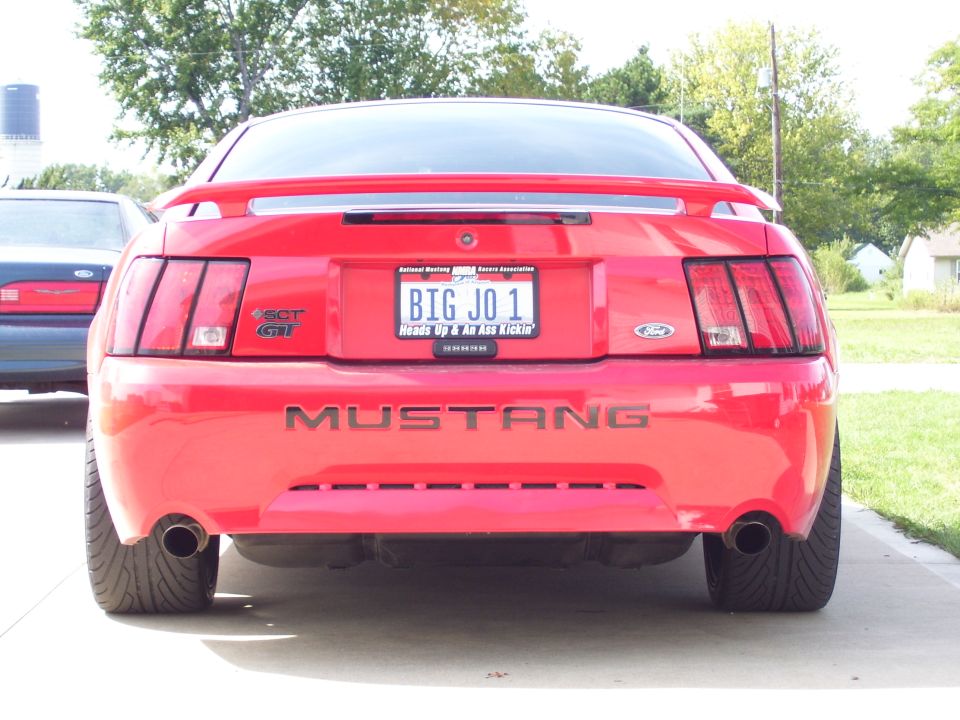 Red 2004 Ford Mustang rear view with custom license plate