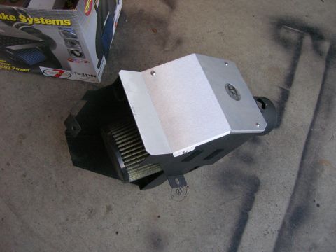 1996 Ford Bronco - A K&N cold air intake system is shown with its filter and heat shield, next to its original packaging.