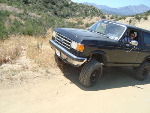 1986 Ford Bronco - This black 1986 Ford Bronco is seen off-road on a sunny day.