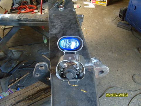 1989 Ford Bronco - Close-up of a trailer hitch assembly with an added blue fog light.