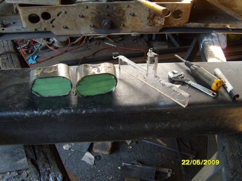 1989 Ford Bronco - Tools and parts are laid out on a workbench, possibly for vehicle maintenance or modification.