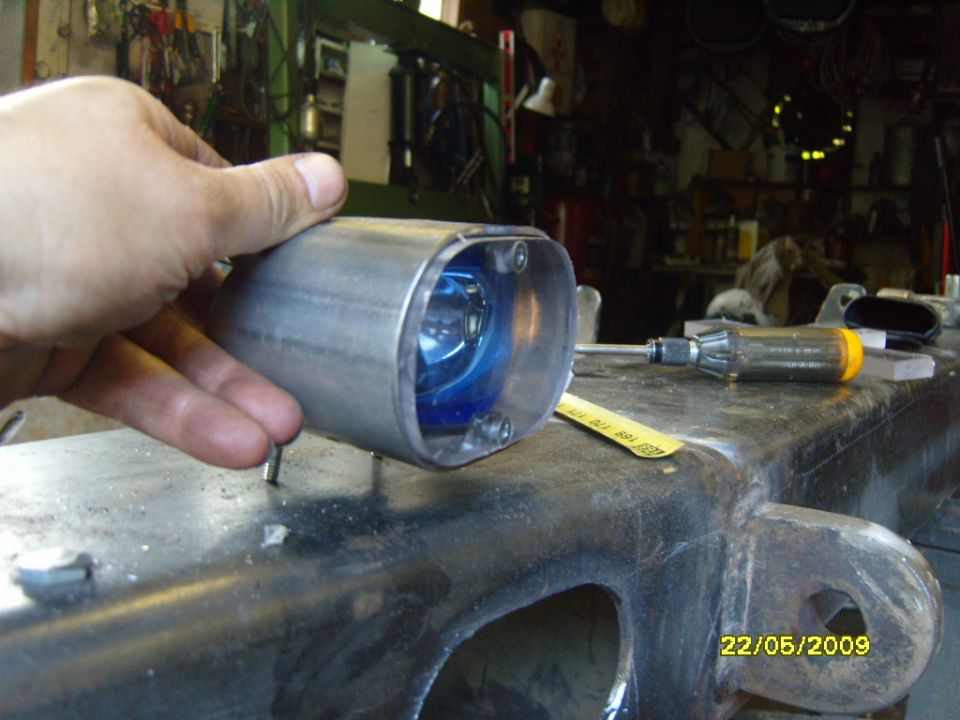 Custom exhaust tip with blue bulb held by hand