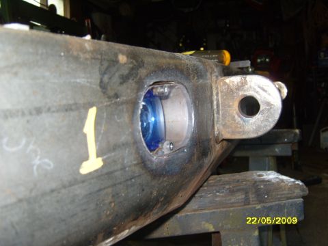 1989 Ford Bronco - A close-up view of a metal component, marked with a yellow '1', a circular opening with a blue element visible within.