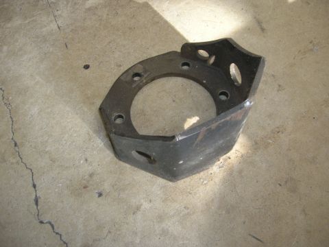 1996 Ford Bronco - This metal bracket, likely a vehicle part, is shown on a concrete surface. Its specific make and model are not identifiable from the image.