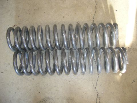 1996 Ford Bronco - A pair of suspension springs are shown resting on a concrete surface.