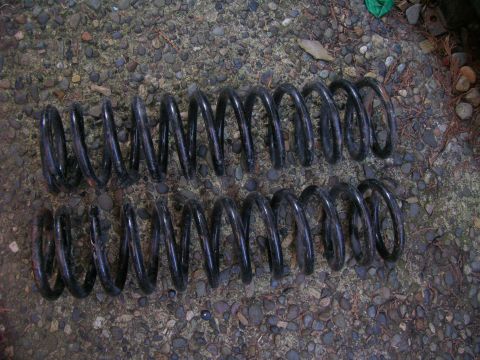 1996 Ford Bronco - Two coil springs are shown on a gravel surface.