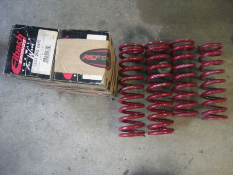 1996 Ford Bronco - Several red coil springs are laid out next to their original packaging boxes.