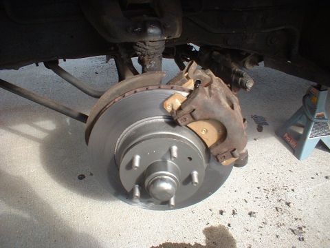 1971 Ford Torino - Close-up view of a vehicle's front brake rotor and caliper, with a Supermotors.net watermark visible.
