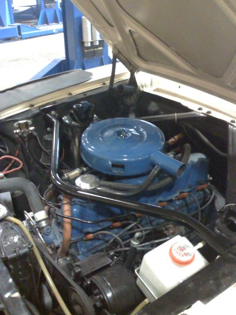 1992 Ford Bronco - Engine bay details with blue air cleaner and visible engine components.