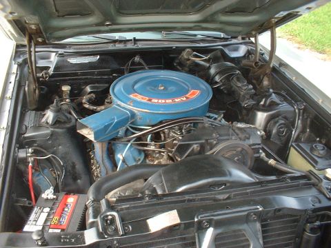 1971 Ford Torino - The engine bay of a 1971 Ford Torino is pictured, its V8 engine and associated components.
