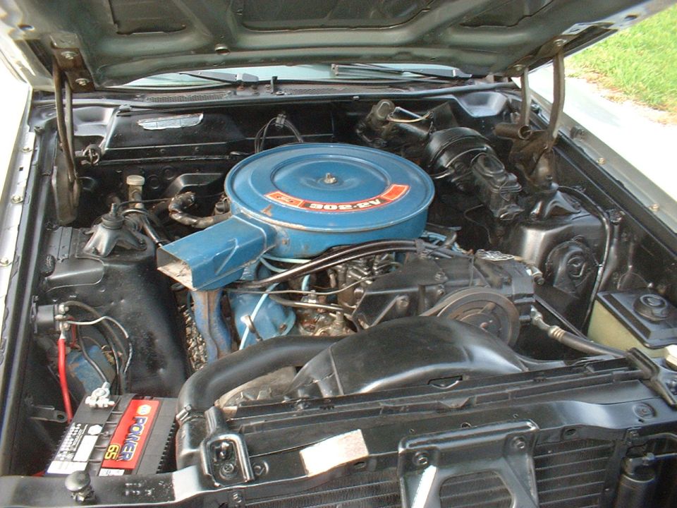 Engine bay of a 1971 Ford Torino. Shows the V8 engine with blue air cleaner and battery