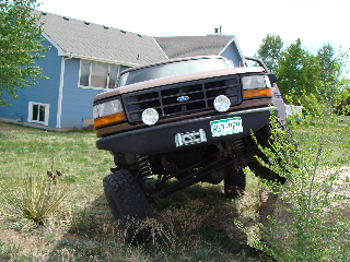 1993 Ford Bronco - This lifted 1993 Ford Bronco is captured in a 3q-front view, its off-road capabilities.
