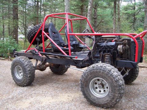 1978 Ford Bronco - Custom off-road buggy with a red roll cage, two seats, and large tires sits outdoors.