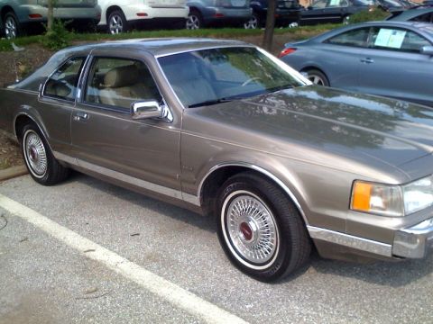 1987 Lincoln Mark VII - This 1987 Lincoln Mark VII coupe is parked in a lot, displaying its front passenger side.
