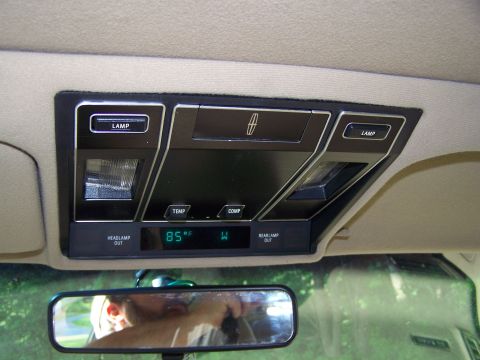 1987 Lincoln Mark VII - Interior view of a car's overhead console, lamp controls and a digital display.