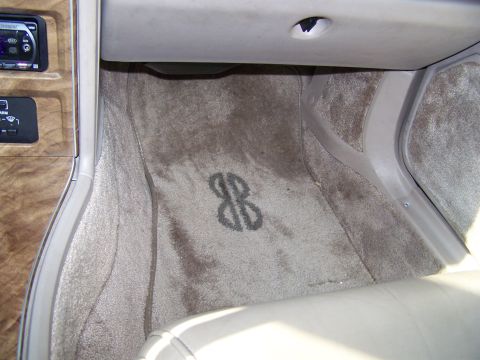 1987 Lincoln Mark VII - Interior shot of a car's floor mat a distinctive logo.