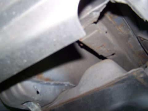 1987 Lincoln Mark VII - Close-up view of the vehicle's undercarriage, showing structural components and signs of rust.