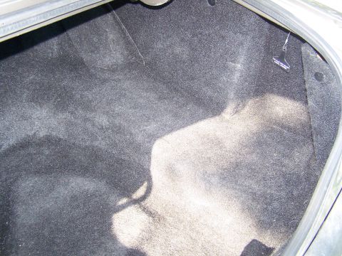 1987 Lincoln Mark VII - The interior of a car's trunk is shown, covered in dark carpeting.