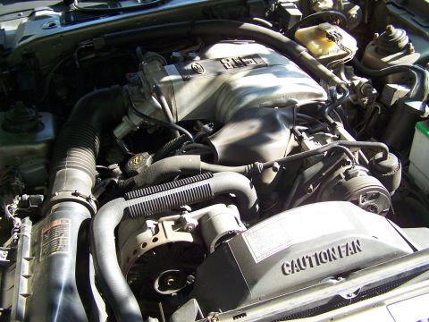 1987 Lincoln Mark VII - Close-up view of a vehicle's engine compartment, showing the intake manifold and fan shroud.