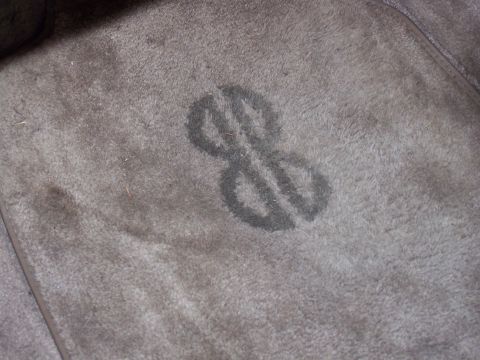 1987 Lincoln Mark VII - A dark gray logo is visible on the gray carpet of a vehicle's interior.