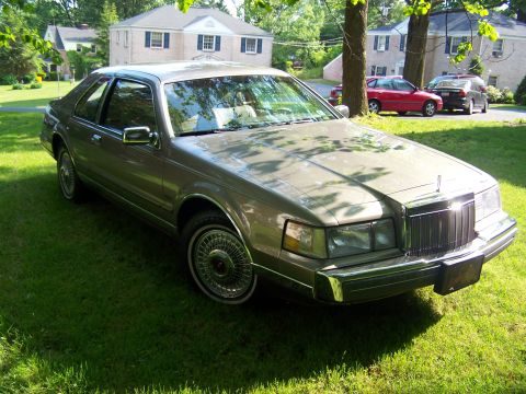 1987 Lincoln Mark VII - This 1987 Lincoln Mark VII coupe is parked on a lawn with houses in the background.