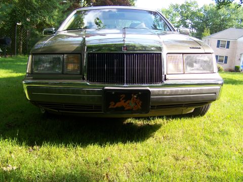 1987 Lincoln Mark VII - This Lincoln Town Car features a prominent vertical grille and a decorative license plate frame.