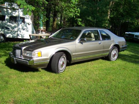 1987 Lincoln Mark VII - This 1987 Lincoln Mark VII is seen parked on a grassy lawn with trees in the background.