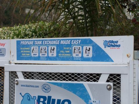 1990 Ford Bronco - Instructions for exchanging propane tanks are displayed on a Blue Rhino sign.