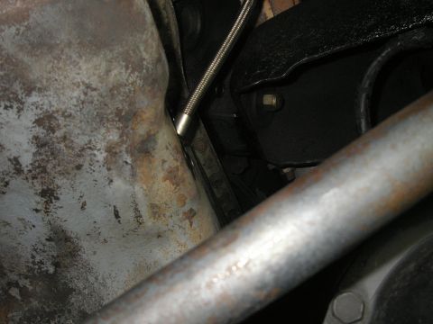 1979 Ford Bronco - Close-up of vehicle undercarriage, focusing on the oil pan and exhaust system.