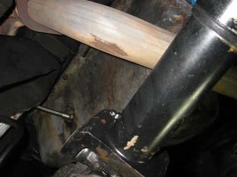 1979 Ford Bronco - Close-up view of the undercarriage, focusing on the exhaust system and structural components.