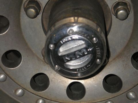 1979 Ford Bronco - Close-up of a wheel hub a Warn locking mechanism, indicating 'LOCK' and 'FREE' settings.
