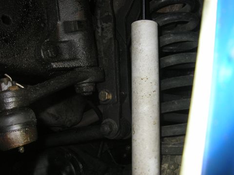 1979 Ford Bronco - Underside view of a vehicle's suspension system, showing mechanical components and a shock absorber.