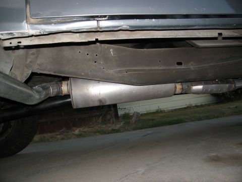 1986 Ford Bronco - Underside view of a vehicle's exhaust system, including the muffler and catalytic converter.