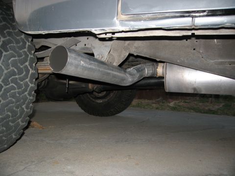 1986 Ford Bronco - Close-up view of a vehicle's exhaust system, including the muffler and tailpipe.