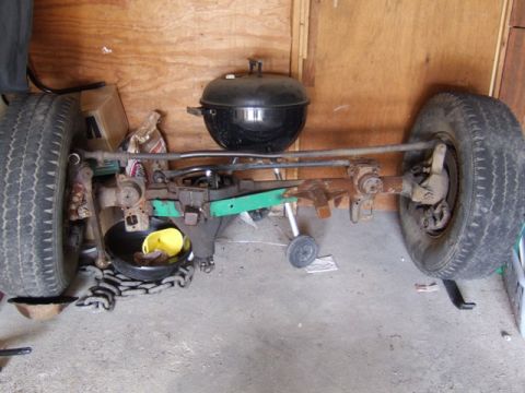2002 Jeep TJ - Front axle assembly with tires and steering components, possibly for a Jeep TJ.