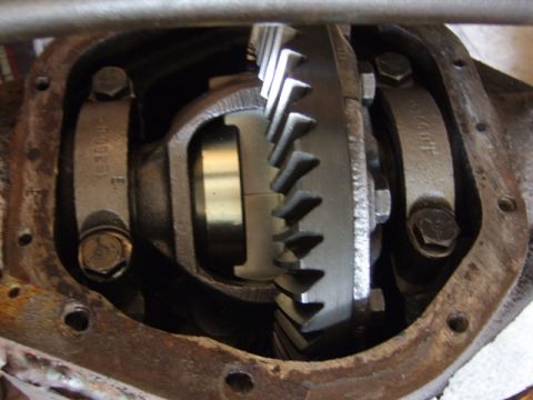 2002 Jeep TJ - Differential gears and bearing caps with visible part numbers in a rusty housing.