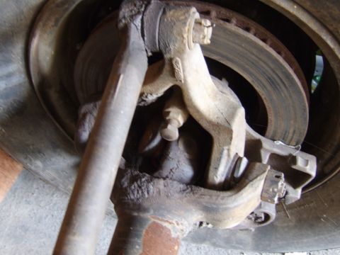 2002 Jeep TJ - This image shows a close-up of a vehicle's front suspension component, including a brake rotor.